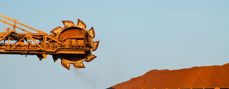 Iron ore machinery in front of a mine site