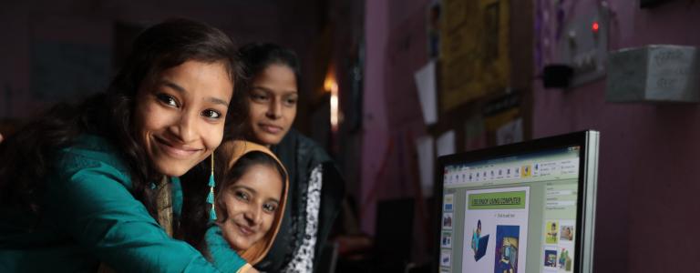 Participants in the Young Women Leadership Program explains software to each other