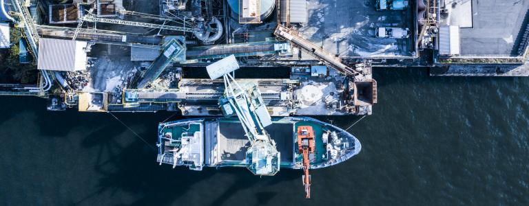 Aerial view of a shipping port and fuel tanks