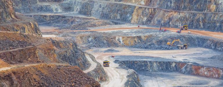 Trucks driving around a copper quarry