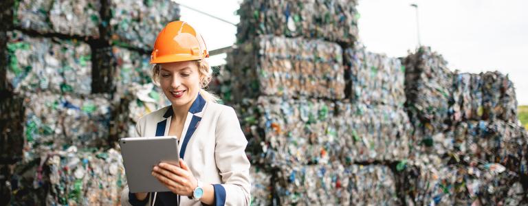 Close-up of female environmental expert using digital tablet for notes while conducting satisfying onsite