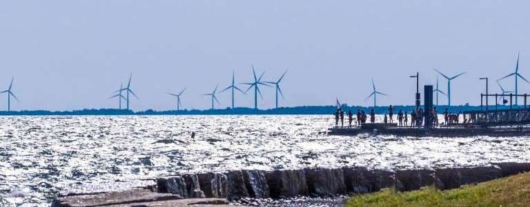 The waterfront area of Kingston, Ontario, Canada with wind turbines in the distance.