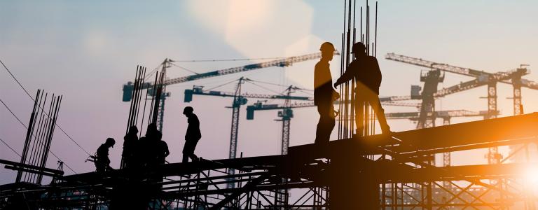 Silhouette of engineer and construction team working at site.