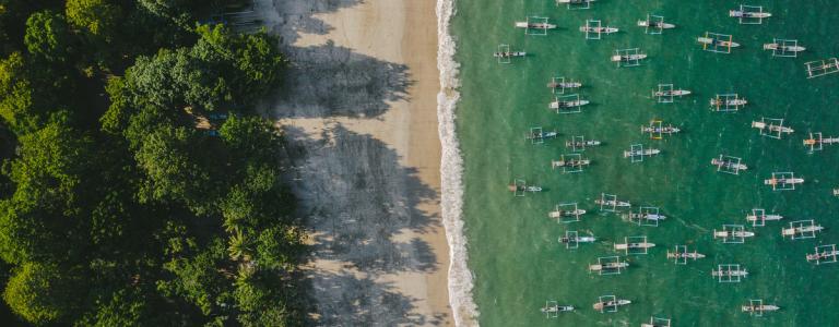 Aerial view of a lot of fishing boats in lagoon on Java, Indonesia.