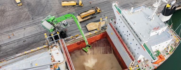 Aerial view of a large general cargo ship loading grain