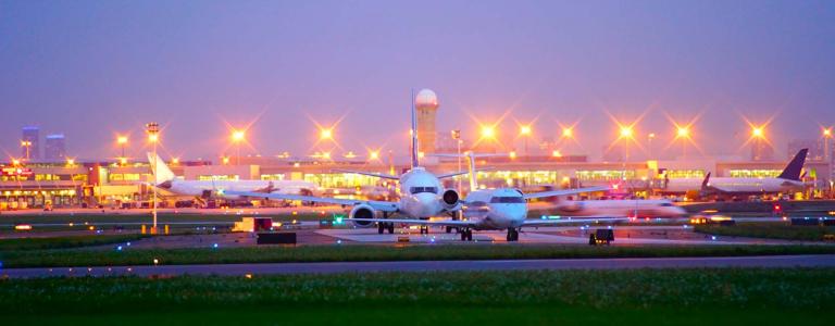 Planes sit on an airport runway