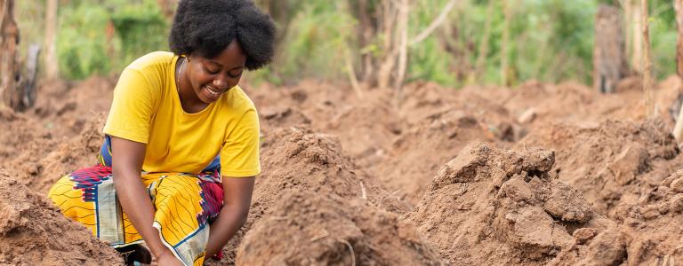 African woman planting in a farm