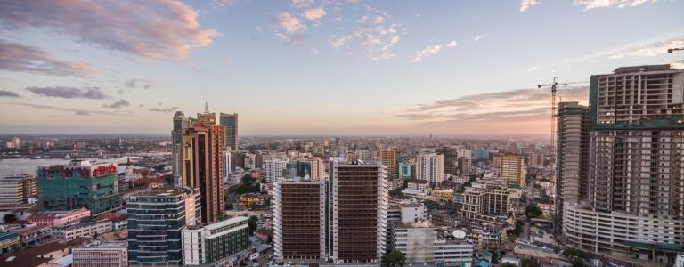 City skyline with a blue sky and clouds and above buidlings