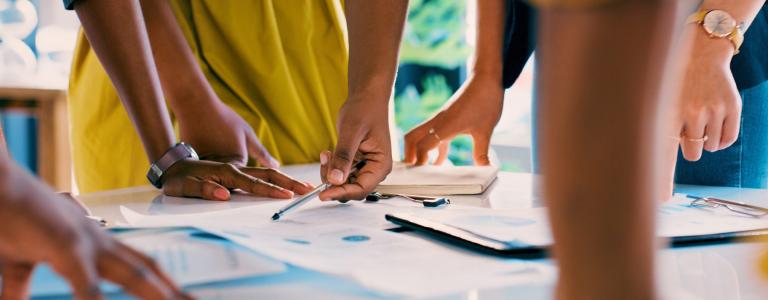 People review paperwork in an office.